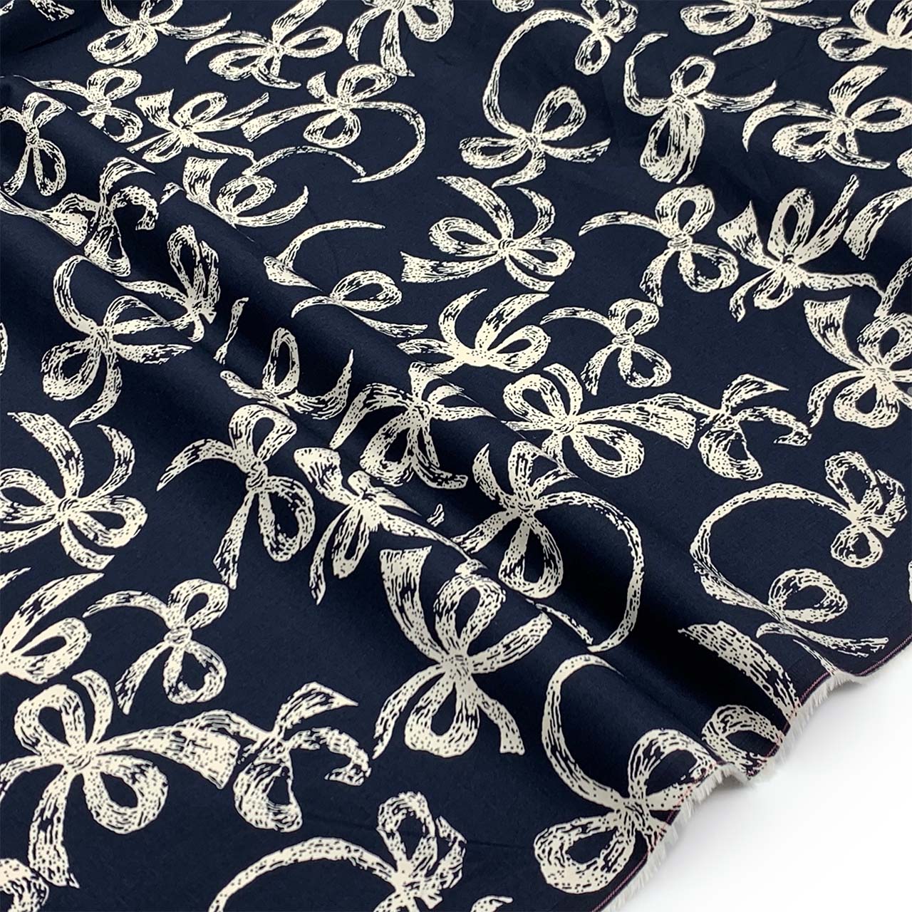 Navy cotton fabric, printed cream bow design on navy - Fabric Collection