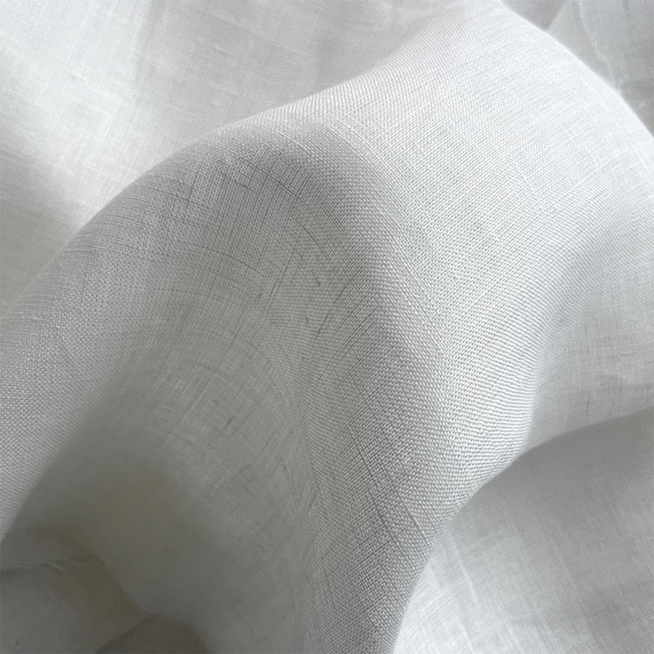 Close-up of white linen lightweight fabric with a classic linen weave - Fabric Collection