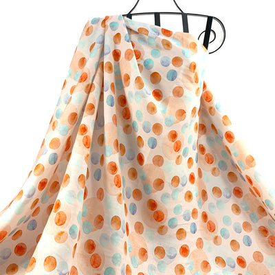 Polka dot fabric with orange ochre and blue dots on a white background 