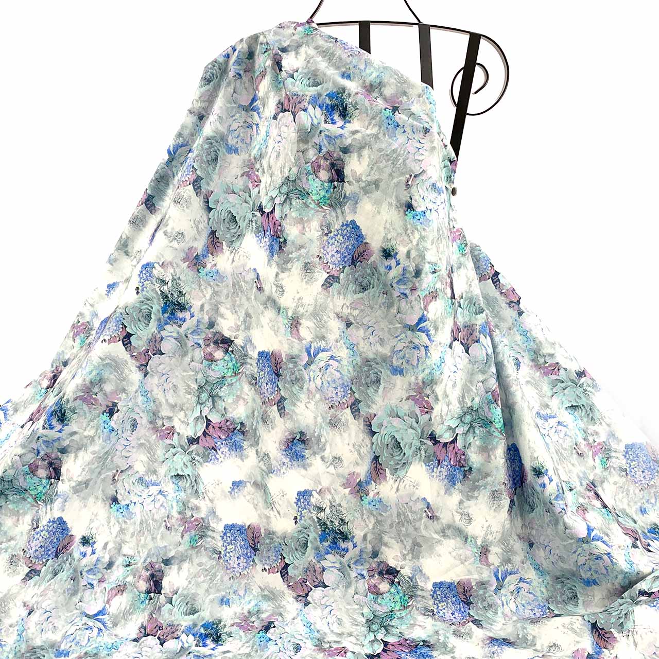 Blue Floral patterned fabric draped against a white background