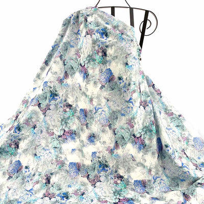Blue Floral patterned fabric draped against a white background