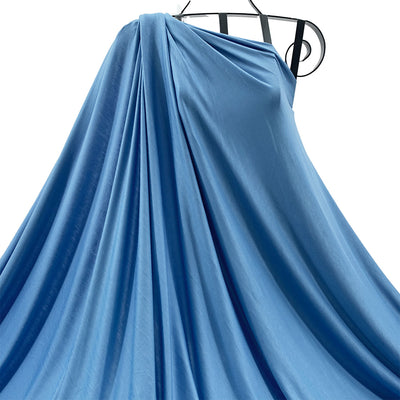 Blue bamboo knit fabric draped on a mannequin against a white background - Fabric Collection
