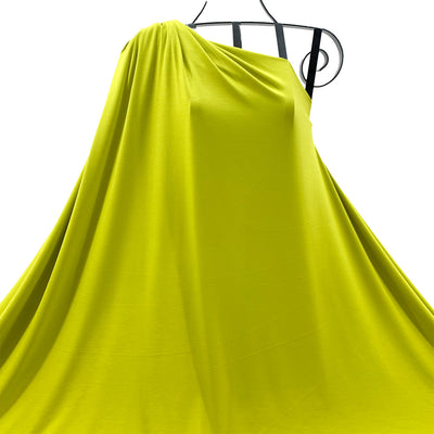 Chartreuse bamboo knit fabric draped on a black mannequin against a white background - Fabric Collection