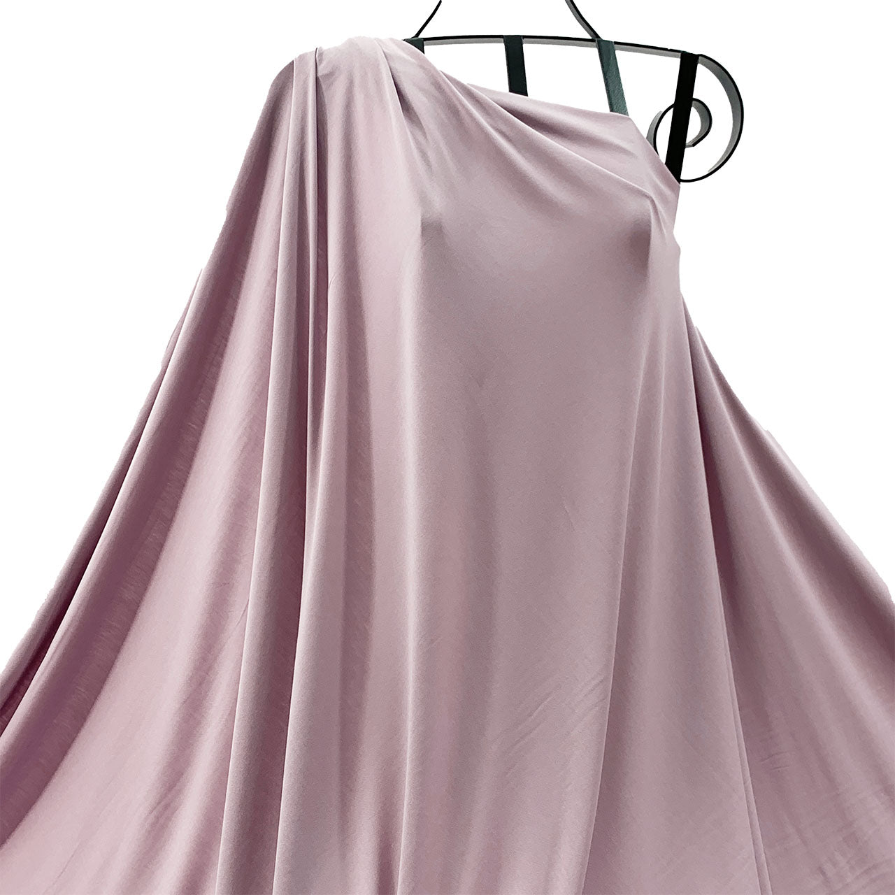 Musk pink bamboo knit fabric draped on a hanger against a white background - Fabric Collection