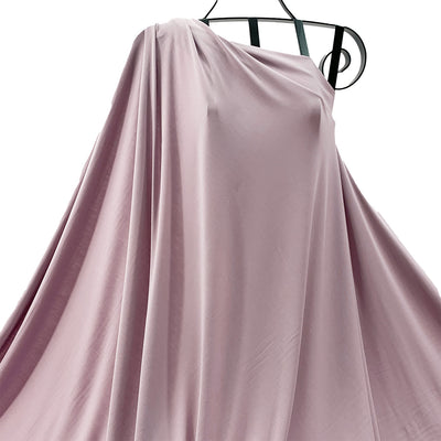Musk pink bamboo knit fabric draped on a hanger against a white background - Fabric Collection