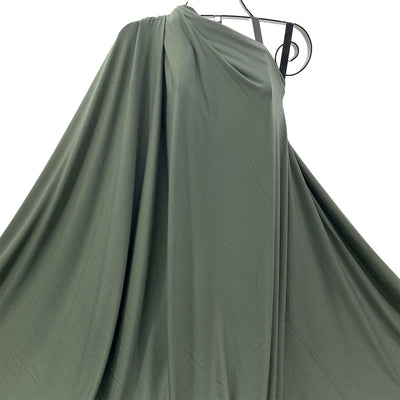 Olive green bamboo knit fabric draped  against a white background - Fabric Collection