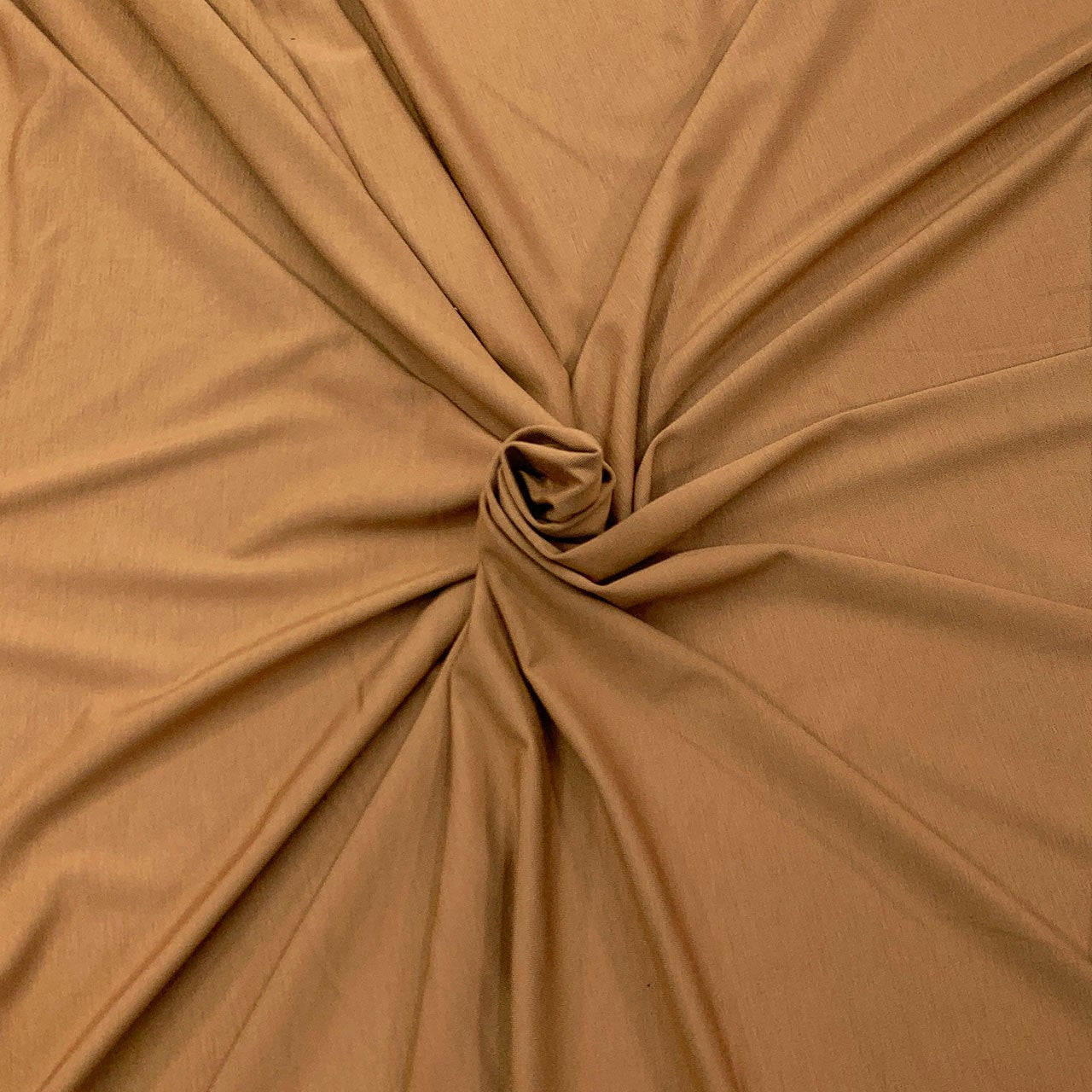 Close-up of bronze brown bamboo knit fabric with a knot - Fabric Collection