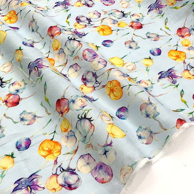 Floral patterned linen fabric with colorful flowers on a light blue background - Fabric Collection