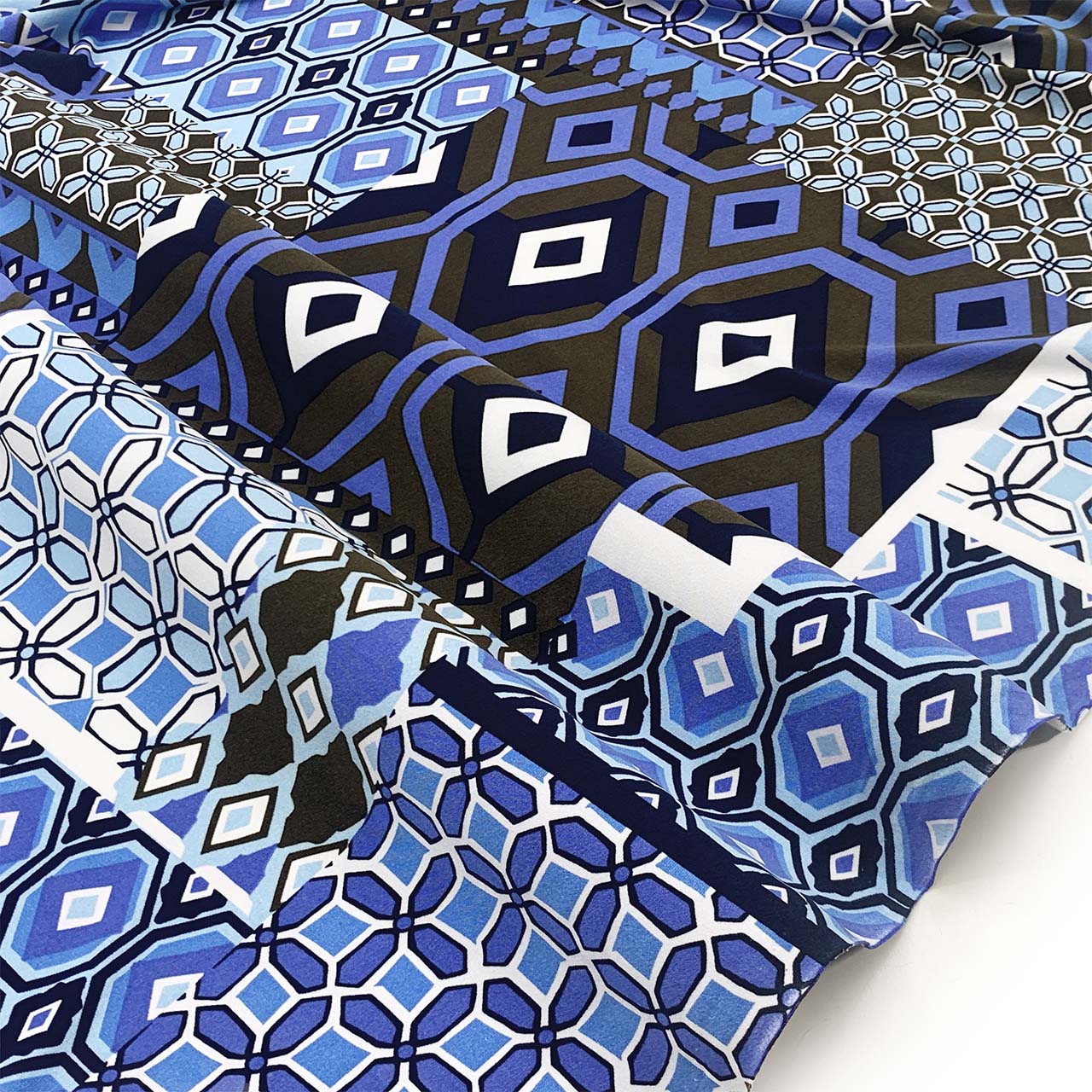 Jersey knit patterned fabric with blue, black, and white geometric design - Fabric Collection