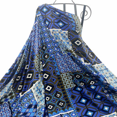 Blue and black jersey knit patterned fabric draped over a metal rod on a white background - Fabric Collection