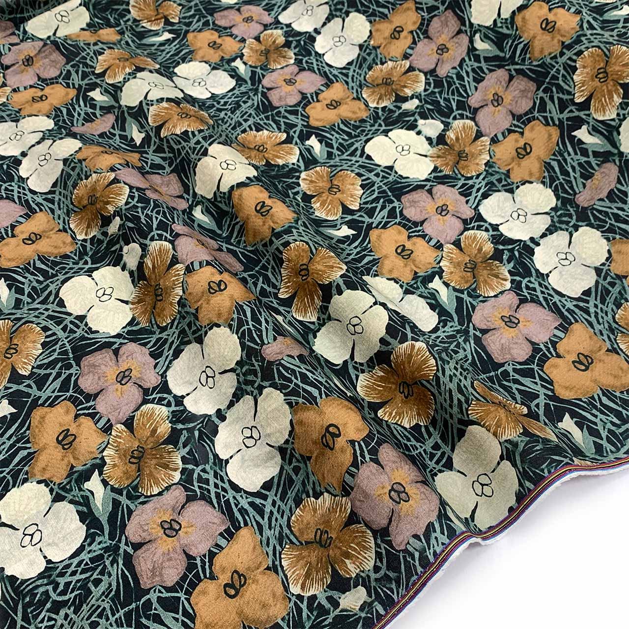 beige tan floral pattern printed on forest green natural fibre linen material
